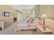 Cozy bedroom features neutral tones, carpet flooring, and ample natural light, creating a relaxing atmosphere at 854 Dahoon Cir, Venice, FL 34293