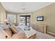 Bedroom with slider doors to the pool features a ceiling fan and light neutral paint at 854 Dahoon Cir, Venice, FL 34293