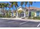 Inviting clubhouse featuring classic architectural design and well-maintained landscaping and convenient parking at 854 Dahoon Cir, Venice, FL 34293