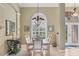 Formal dining room with a decorative chandelier and plantation shutters at 854 Dahoon Cir, Venice, FL 34293