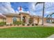 Charming single-story home featuring a well-manicured lawn, lush landscaping, and a welcoming double-door entry at 854 Dahoon Cir, Venice, FL 34293