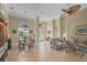 Open-concept living area with tile floors, arched windows, and a view of the adjacent dining room at 854 Dahoon Cir, Venice, FL 34293