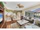 Spacious living room with an open floor plan, hardwood floors, and seamless access to the screened lanai and pool at 854 Dahoon Cir, Venice, FL 34293