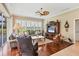 Cozy living room with hardwood floors, plantation shutters, and comfortable seating for relaxing or entertaining at 854 Dahoon Cir, Venice, FL 34293