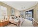 Serene main bedroom with private access to the pool area, providing a peaceful retreat with natural light at 854 Dahoon Cir, Venice, FL 34293
