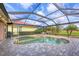 A lovely backyard featuring a kidney-shaped pool and spa surrounded by paved patio and screened-in enclosure at 854 Dahoon Cir, Venice, FL 34293