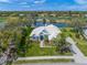 An elegant home boasts lush landscaping and serene water views from its vantage point at 8807 Wild Dunes Dr, Sarasota, FL 34241