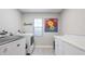 Functional laundry room with a modern washer and dryer, ample counter space, and a window for natural light at 9158 16Th Avenue Nw Cir, Bradenton, FL 34209