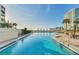 Enjoy a refreshing swim in the pool with lounge chairs, palm trees and ocean views at 97 Sunset Dr # 202, Sarasota, FL 34236