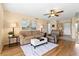 Cozy living room featuring wood floors, ceiling fan, and comfortable seating at 3660 Ironwood Cir # 205M, Bradenton, FL 34209