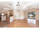 Bright living room featuring hardwood floors, high ceilings, ceiling fan, and sliding glass doors to the pool area at 11219 Coralbean Dr, Lakewood Ranch, FL 34202