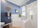 This luxurious bathroom showcases a corner soaking tub and a modern glass-enclosed shower at 12151 Amica Loop, Venice, FL 34293