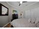 Cozy bedroom showcases a queen bed, wood flooring, flat screen TV, large dresser, and a closet at 12151 Amica Loop, Venice, FL 34293