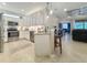 Open kitchen featuring stainless appliances, a breakfast bar, and tile flooring at 12151 Amica Loop, Venice, FL 34293