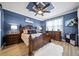 Elegant main bedroom with a decorative ceiling, a large carved wood bed frame, and blue accent wall at 12151 Amica Loop, Venice, FL 34293