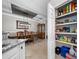 Dining room view adjacent to a walk-in pantry with ample shelved storage at 12151 Amica Loop, Venice, FL 34293