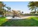 Community playground for residents to enjoy, with covered play structure and green lawn area at 12151 Amica Loop, Venice, FL 34293
