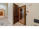 Community sauna with a wooden door with glass, tile flooring and proper guidelines posted at 12151 Amica Loop, Venice, FL 34293