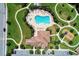 An aerial view captures the community pool and playground with winding sidewalks and lush green landscaping at 12263 Lavender Loop, Bradenton, FL 34212