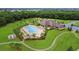 Stunning aerial view of the community pool, clubhouse, playground, and lush landscaping at 12263 Lavender Loop, Bradenton, FL 34212