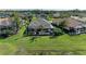 Aerial view of a screened-in lanai, large backyard, and tropical landscaping at 12263 Lavender Loop, Bradenton, FL 34212
