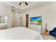 A calming bedroom featuring a ceiling fan, white linens and wood look floors at 12263 Lavender Loop, Bradenton, FL 34212