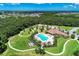 Aerial view of neighborhood pool and playground nestled among trees and walking path at 12263 Lavender Loop, Bradenton, FL 34212