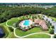 Aerial shot of a community pool and clubhouse among walking paths and trees at 12263 Lavender Loop, Bradenton, FL 34212