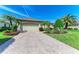Charming home featuring lush landscaping, a brick driveway, and a well-maintained lawn at 12263 Lavender Loop, Bradenton, FL 34212