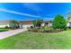 Charming home featuring lush landscaping, a brick driveway, and a well-maintained lawn at 12263 Lavender Loop, Bradenton, FL 34212