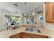 Kitchen featuring stainless steel sink and faucet, light colored counters and dining area in view at 12263 Lavender Loop, Bradenton, FL 34212