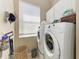 A functional laundry area includes a washer, dryer, storage and natural light at 12263 Lavender Loop, Bradenton, FL 34212