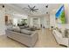 Bright living room features a comfortable sectional, ceiling fan and access to outdoor space at 12263 Lavender Loop, Bradenton, FL 34212