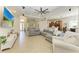 An open living room leads to kitchen with recessed lights, tile floors and neutral decor at 12263 Lavender Loop, Bradenton, FL 34212