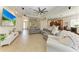 An open living room leads to kitchen with recessed lights, tile floors, and neutral decor at 12263 Lavender Loop, Bradenton, FL 34212