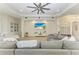 A modern living room features a ceiling fan, recessed lights and a large sectional sofa at 12263 Lavender Loop, Bradenton, FL 34212