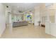 Spacious living room featuring tile floors, a ceiling fan and a large sectional couch at 12263 Lavender Loop, Bradenton, FL 34212