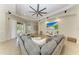 Relaxing living room with a large sectional couch, ceiling fan and recessed lights at 12263 Lavender Loop, Bradenton, FL 34212