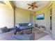 Cozy outdoor space features comfortable seating, a ceiling fan, and a TV at 12263 Lavender Loop, Bradenton, FL 34212