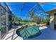 Relax by the screened pool overlooking the picturesque pond with outdoor lounge chairs for added comfort at 12263 Lavender Loop, Bradenton, FL 34212