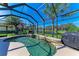 The screened pool area offers a serene view of the pond, complemented by a grill for outdoor cooking at 12263 Lavender Loop, Bradenton, FL 34212
