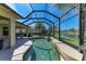 Enjoy the tranquil pond views from the screened pool area, complete with comfortable seating and outdoor dining space at 12263 Lavender Loop, Bradenton, FL 34212