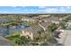 An aerial view of townhomes shows mature trees and a tranquil pond at 14932 Amberjack Ter, Lakewood Ranch, FL 34202