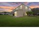 Expansive backyard showcasing lush green grass, and the home's facade at 14932 Amberjack Ter, Lakewood Ranch, FL 34202