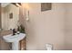 Powder room featuring a pedestal sink, decorative wall art and beige walls at 14932 Amberjack Ter, Lakewood Ranch, FL 34202