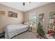 Neutral toned bedroom with ceiling fan, large window view, and single bed at 14932 Amberjack Ter, Lakewood Ranch, FL 34202