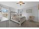 Bright bedroom boasts neutral tones, large windows, and a ceiling fan at 14932 Amberjack Ter, Lakewood Ranch, FL 34202