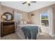 Cozy bedroom with natural light, decorative mirror, and neutral colored walls at 14932 Amberjack Ter, Lakewood Ranch, FL 34202