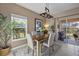 Cozy dining area with a modern chandelier and access to an outdoor patio at 14932 Amberjack Ter, Lakewood Ranch, FL 34202
