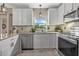 Bright kitchen showcases granite counters, stainless steel appliances, and white cabinets at 14932 Amberjack Ter, Lakewood Ranch, FL 34202